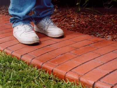 person standing on stamped brick border